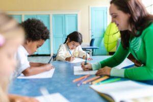: https://www.pexels.com/photo/a-woman-in-green-long-sleeves-teaching-kids-in-school-8363163/