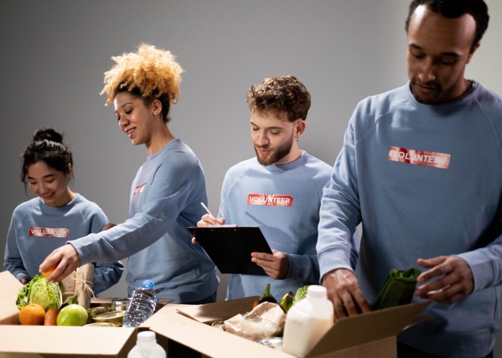 https://www.pexels.com/photo/a-group-of-volunteers-assisting-an-elderly-person-on-a-black-wheelchair-for-charity-6646917/