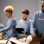 https://www.pexels.com/photo/a-group-of-volunteers-assisting-an-elderly-person-on-a-black-wheelchair-for-charity-6646917/