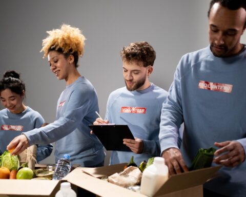 https://www.pexels.com/photo/a-group-of-volunteers-assisting-an-elderly-person-on-a-black-wheelchair-for-charity-6646917/